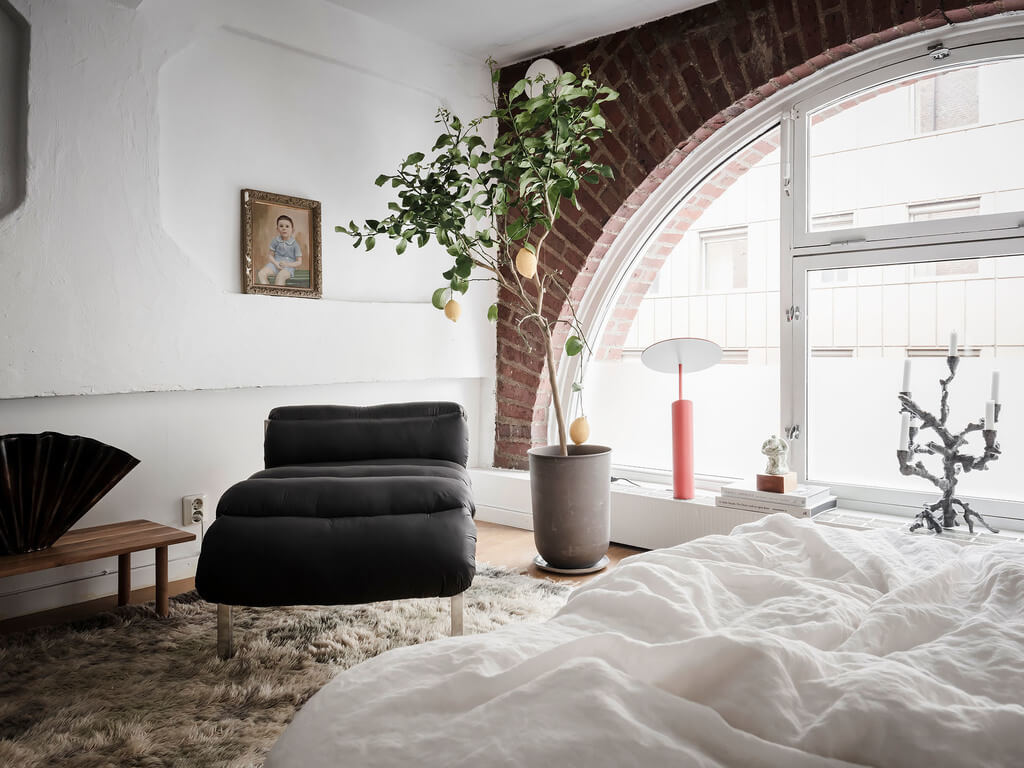 A Scandinavian Loft with Brick Wall and Arched Window 8 bedroom-lounge-chair-brick-wall-nordroom