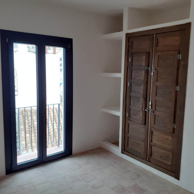 Casita Alborán: A Stylish Home in a Spanish Seaside Town 19 bedroom-rustic-wooden-doors-built-in-wardrobes-nordroom