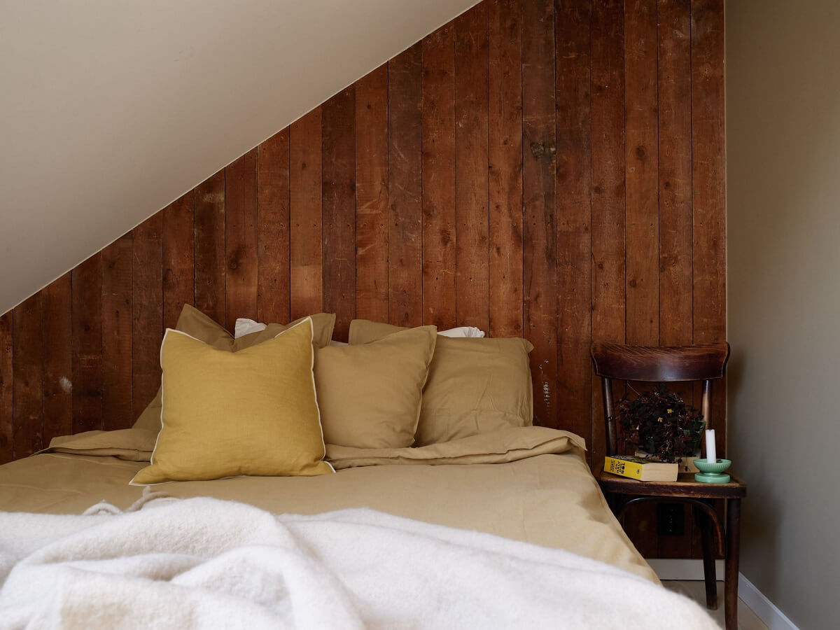 A Scandinavian Penthouse Apartment with Slanted Ceilings 13 bedroom-slanted-ceiling-reclaimed-wood-accent-wall-nordroom