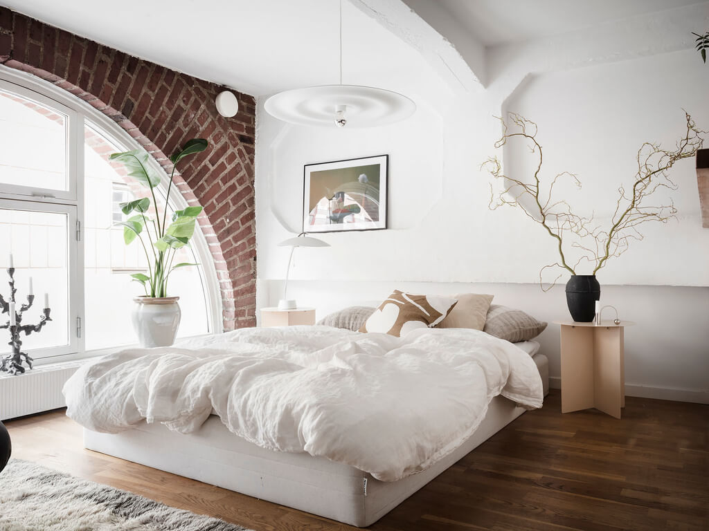 A Scandinavian Loft with Brick Wall and Arched Window 10 bedroom-wooden-floor-brick-wall-arched-window-white-bedding-nordroom