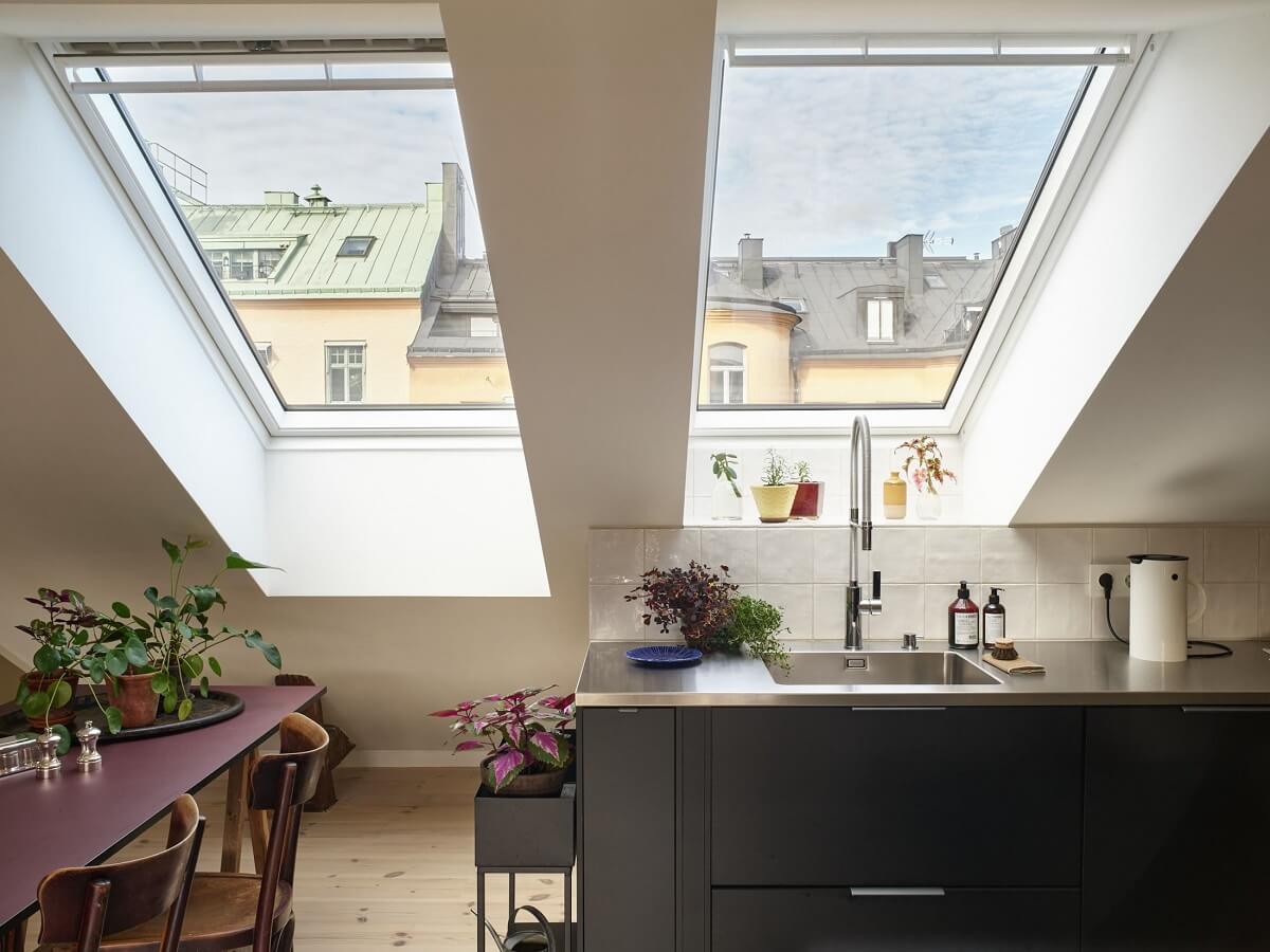 A Scandinavian Penthouse Apartment with Slanted Ceilings 4 black-kitchen-skylights-slanted-ceilings-nordroom
