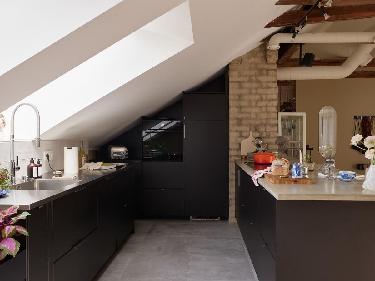A Scandinavian Penthouse Apartment with Slanted Ceilings 3 black-kitchen-slanted-wall-penthouse-nordroom