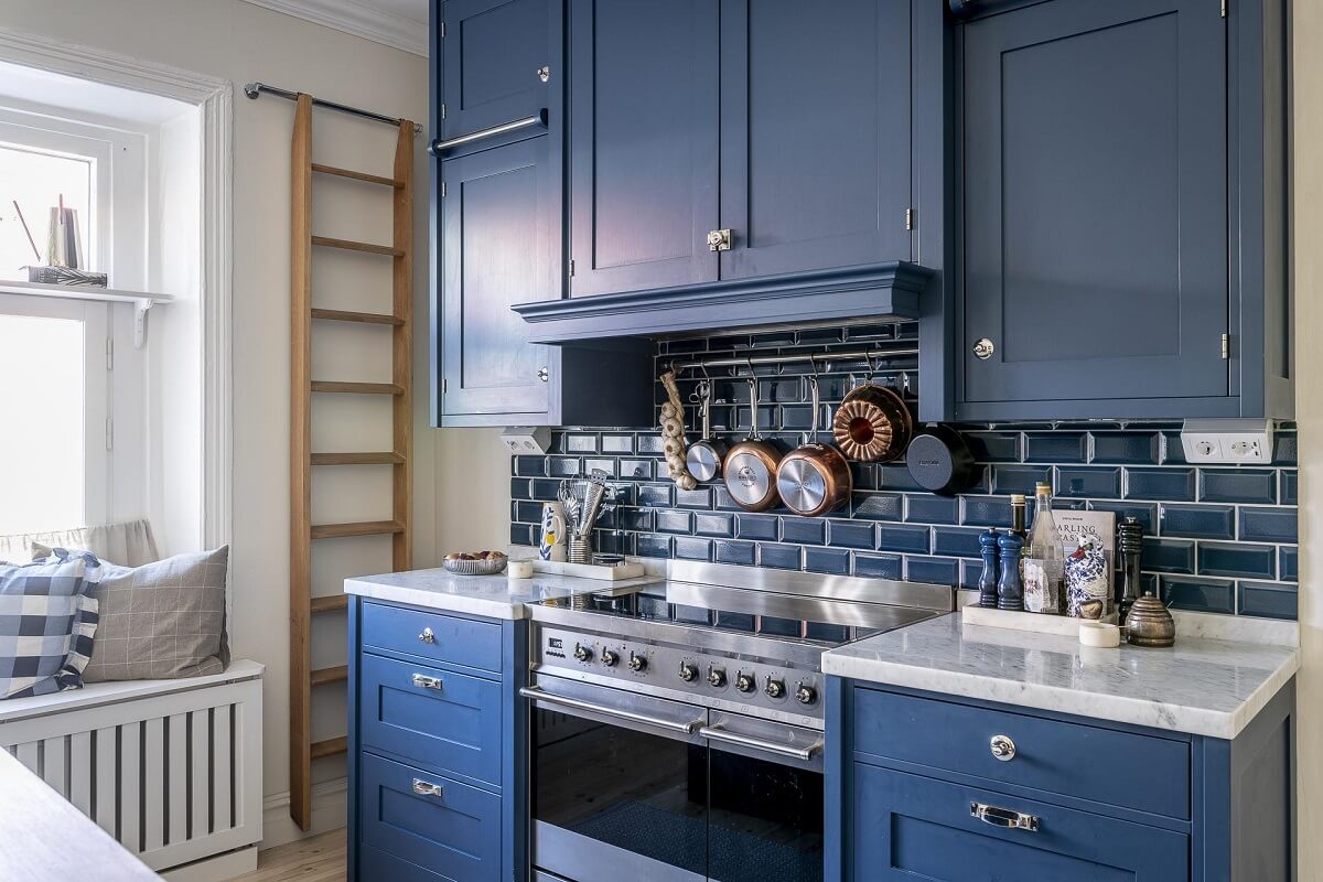 A Swedish Maisonette with a Blue Kitchen and Wallpaper 10 blue-kitchen-cabinets-blue-backsplash-tiles-nordroom
