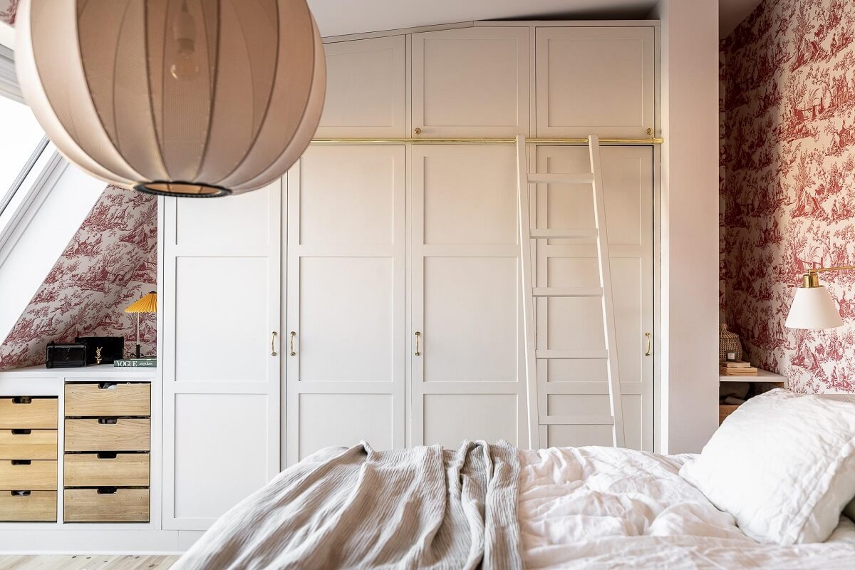 A Swedish Maisonette with a Blue Kitchen and Wallpaper 20 built-in-wardrobes-slanted-ceiling-wallpaper-master-bedroom-nordroom