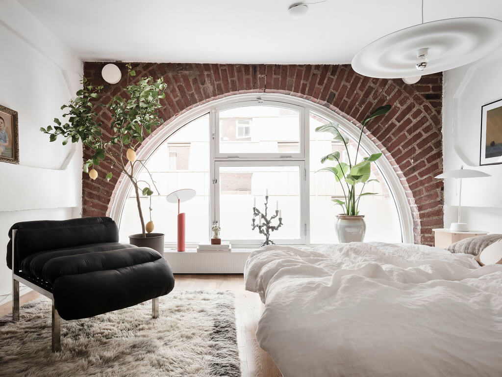 A Scandinavian Loft with Brick Wall and Arched Window 7 exposed-brick-wall-arched-window-bedroom-nordroom