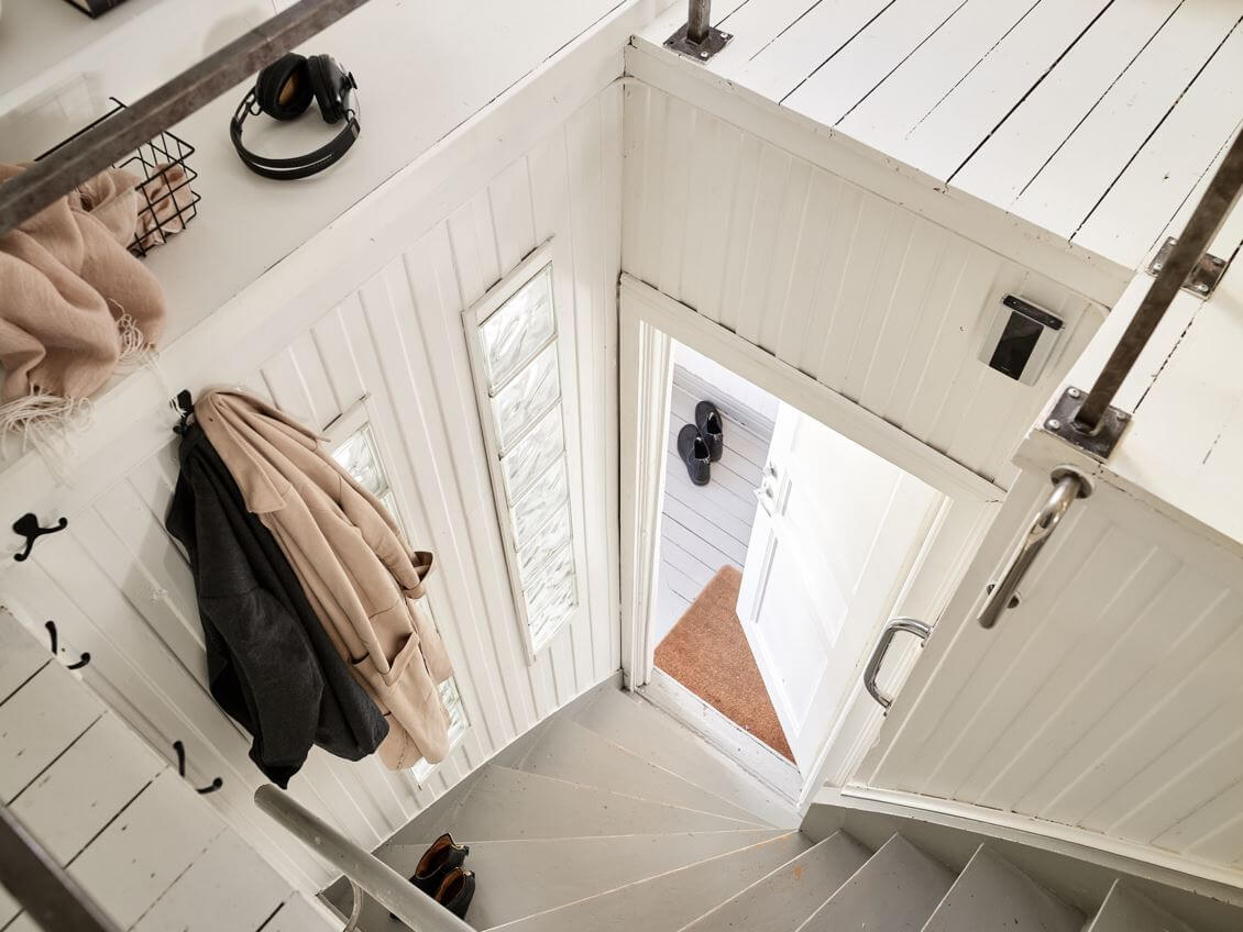 A White Scandinavian Attic Apartment 20 front-door-staircase-attic-apartment-nordroom