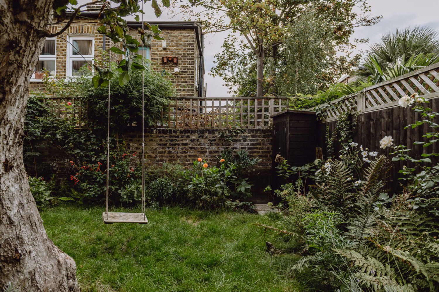 A Victorian Watch Shop is Now a Warm Sustainable Home 23 garden apple tree swing nordroom