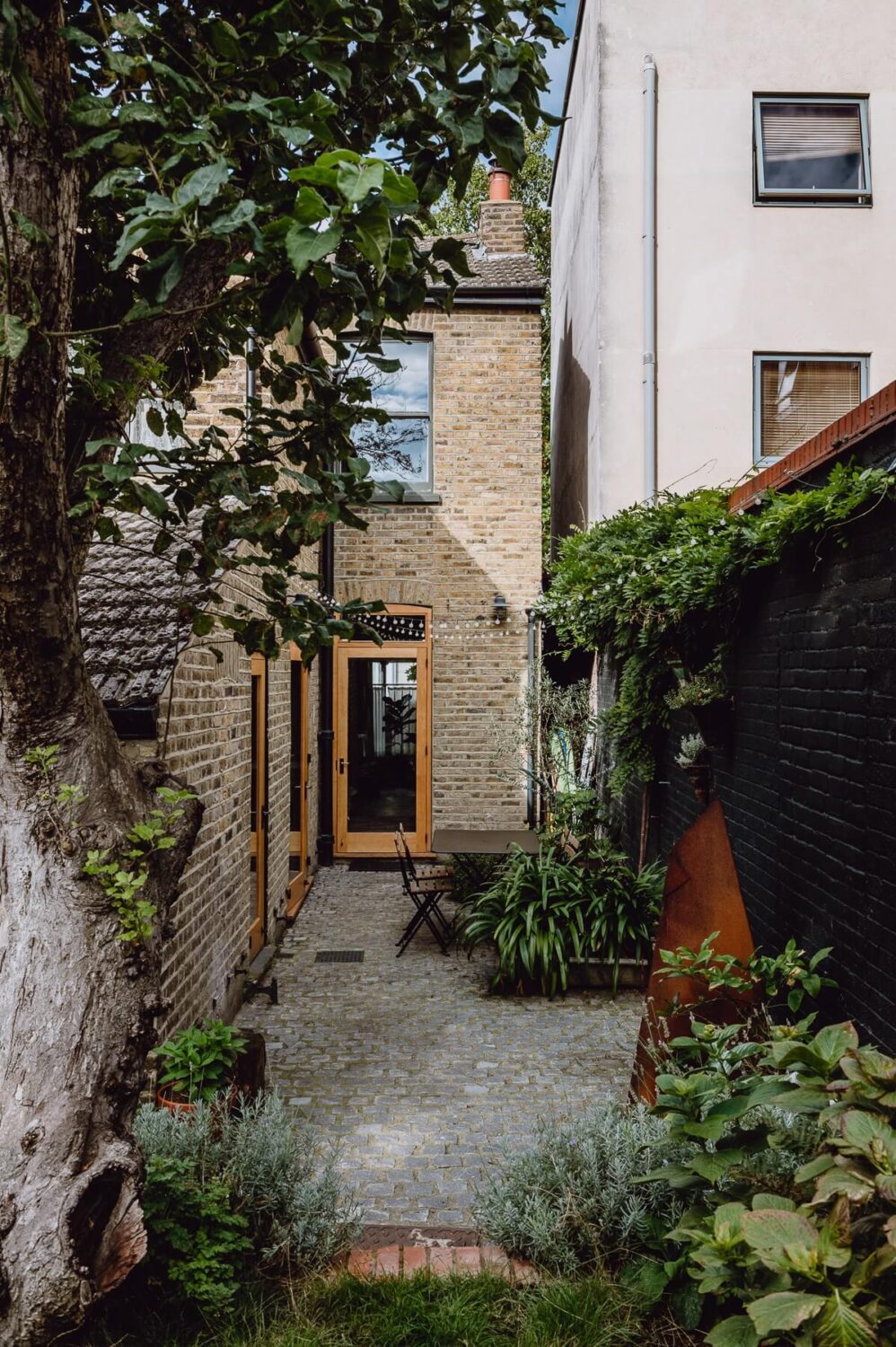A Victorian Watch Shop is Now a Warm Sustainable Home 25 garden terrace apple tree former shop london nordroom