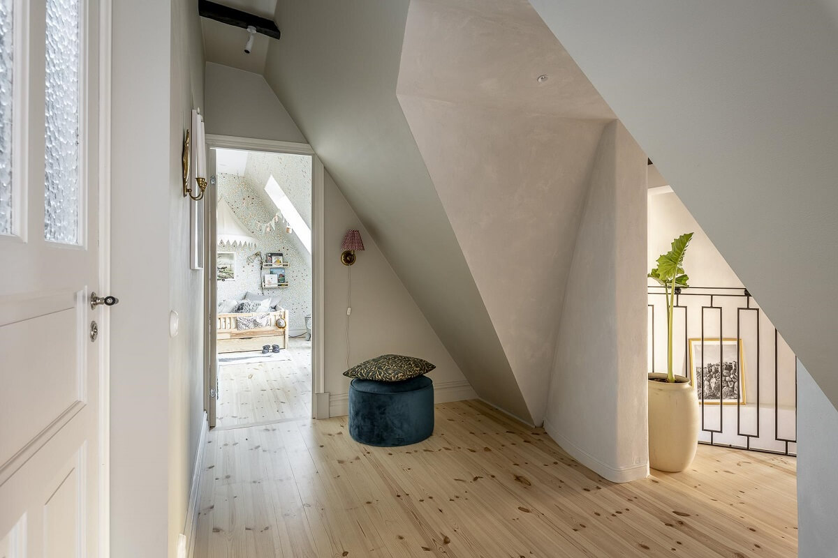 A Swedish Maisonette with a Blue Kitchen and Wallpaper 15 hallway-wooden-floor-slanted-ceilings-nordroom