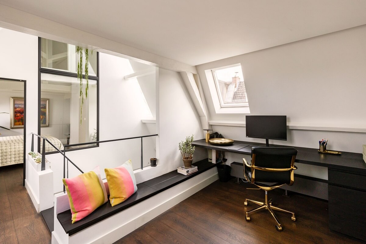 An Amsterdam Penthouse with Green Color Accents 13 home-office-black-desk-bench-slanted-ceiling-nordroom