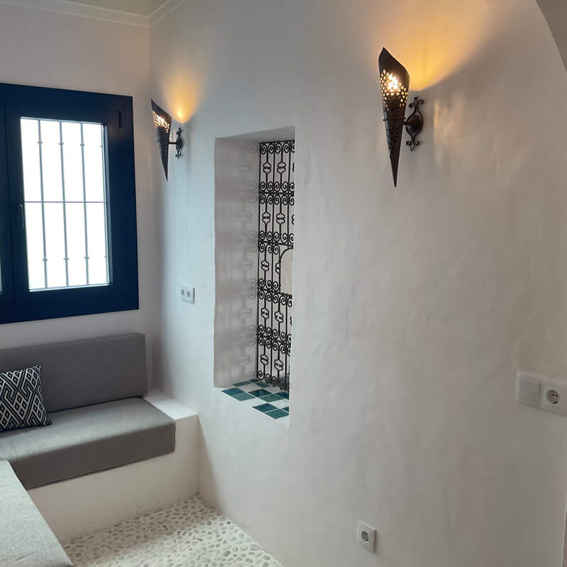 Casita Alborán: A Stylish Home in a Spanish Seaside Town 14 indoor-patio-pebble-floor-moroccan-grille-window-nordroom
