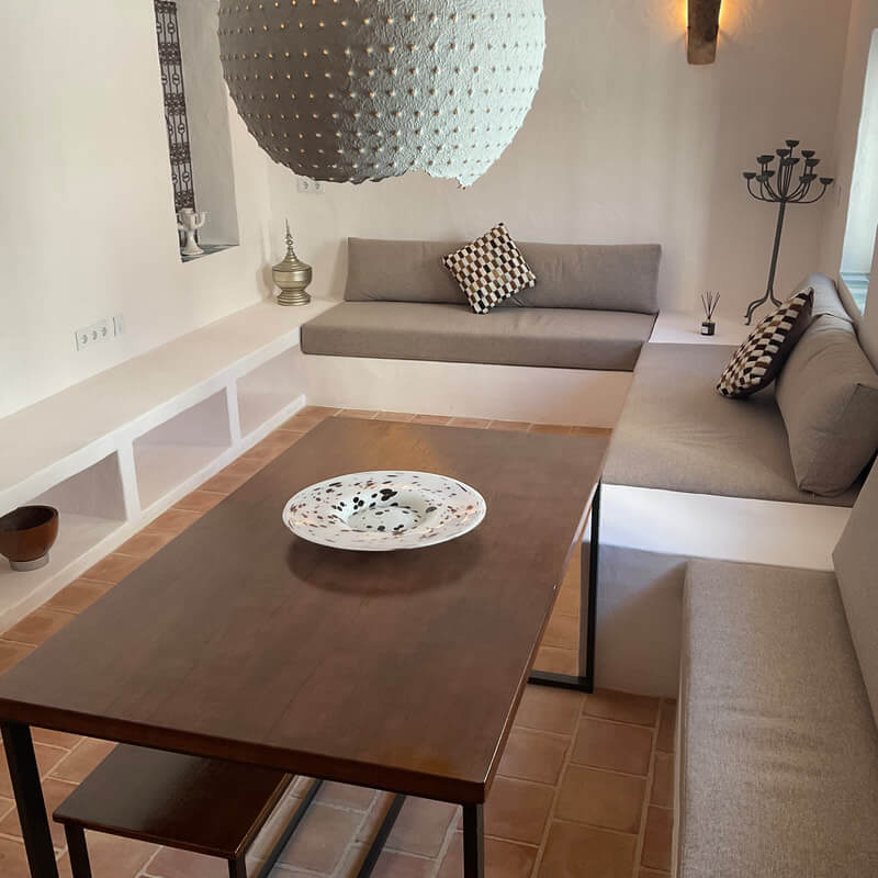Casita Alborán: A Stylish Home in a Spanish Seaside Town 2 iving-room-built-in-sofas-dining-table-nordroom