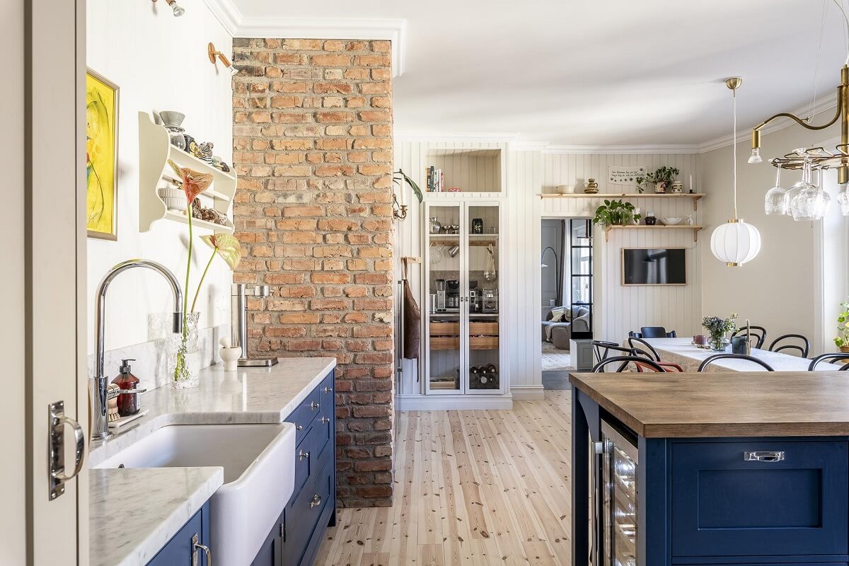 A Swedish Maisonette with a Blue Kitchen and Wallpaper 12 kitchen-blue-cabinets-exposed-brick-wall-nordroom