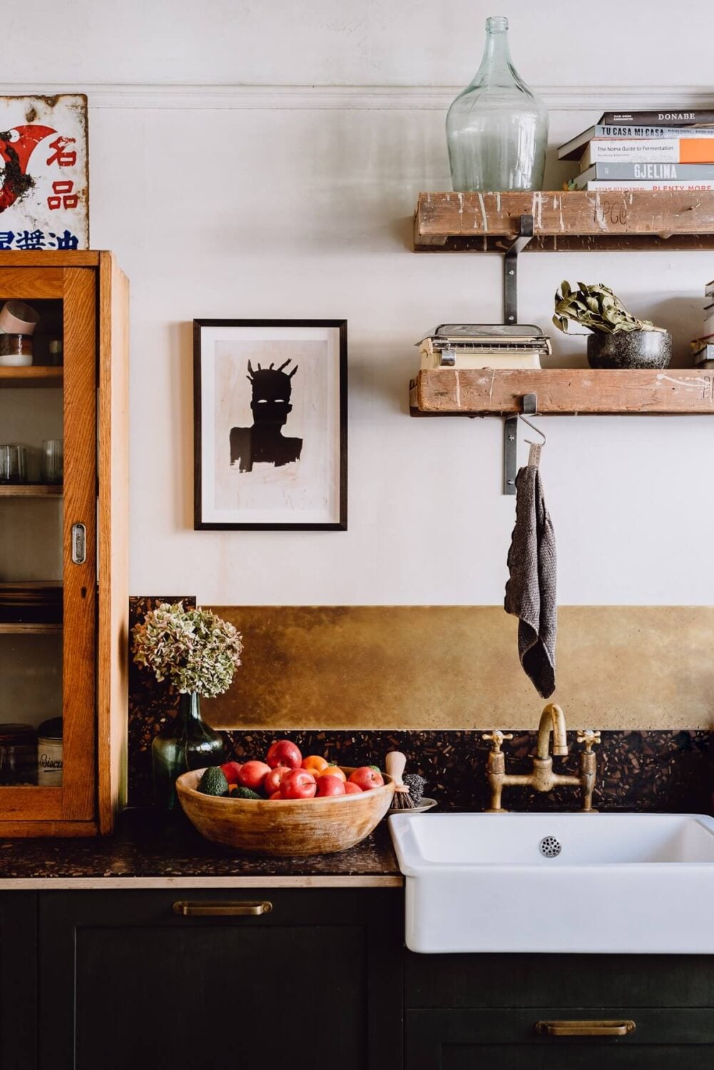 A Victorian Watch Shop is Now a Warm Sustainable Home 2 kitchen detail brass backsplash black cabinets nordroom