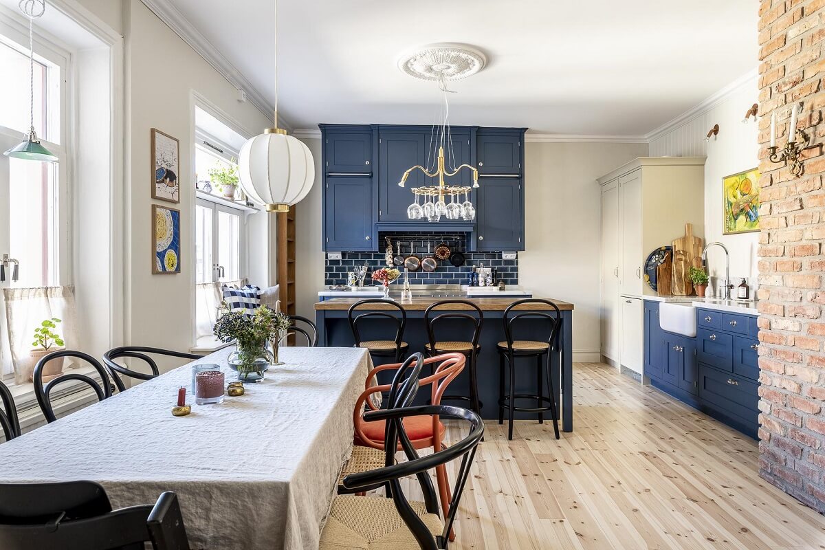 A Swedish Maisonette with a Blue Kitchen and Wallpaper 7 kitchen-dining-room-blue-cabinets-brick-wall-nordroom