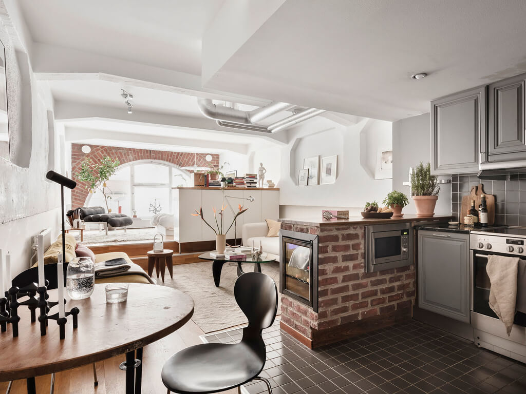 A Scandinavian Loft with Brick Wall and Arched Window 17 kitchen-small-dining-table-black-tiles-nordroom