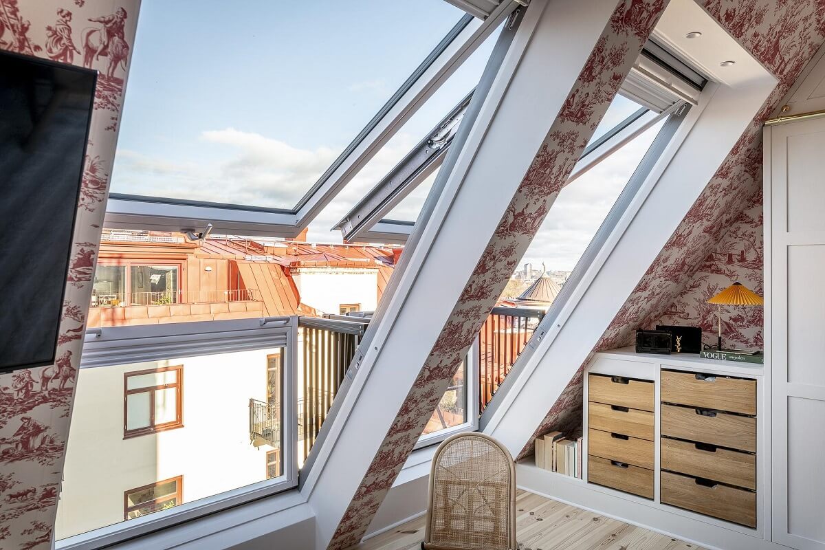 A Swedish Maisonette with a Blue Kitchen and Wallpaper 19 large-skylights-slanted-wall-wallpaper-bedroom-nordroom