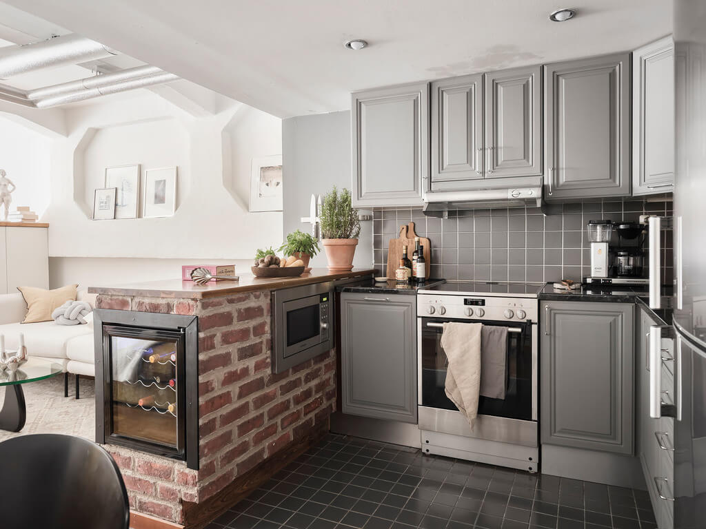 A Scandinavian Loft with Brick Wall and Arched Window 19 light-gray-kitchen-brick-wall-wine-cooler-nordroom