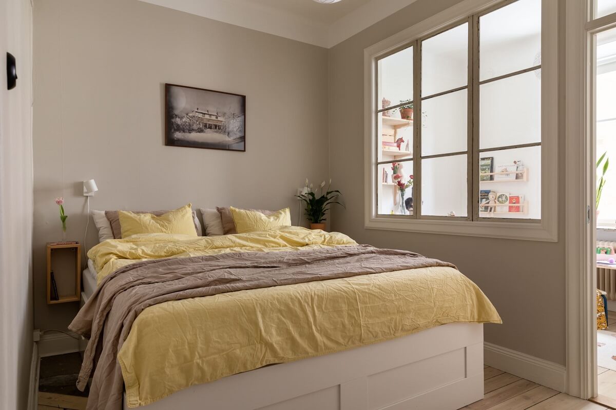 A Pink Living Room in a Scandinavian Apartment 12 light-gray-walls-bedroom-yellow-bedding-nordroom
