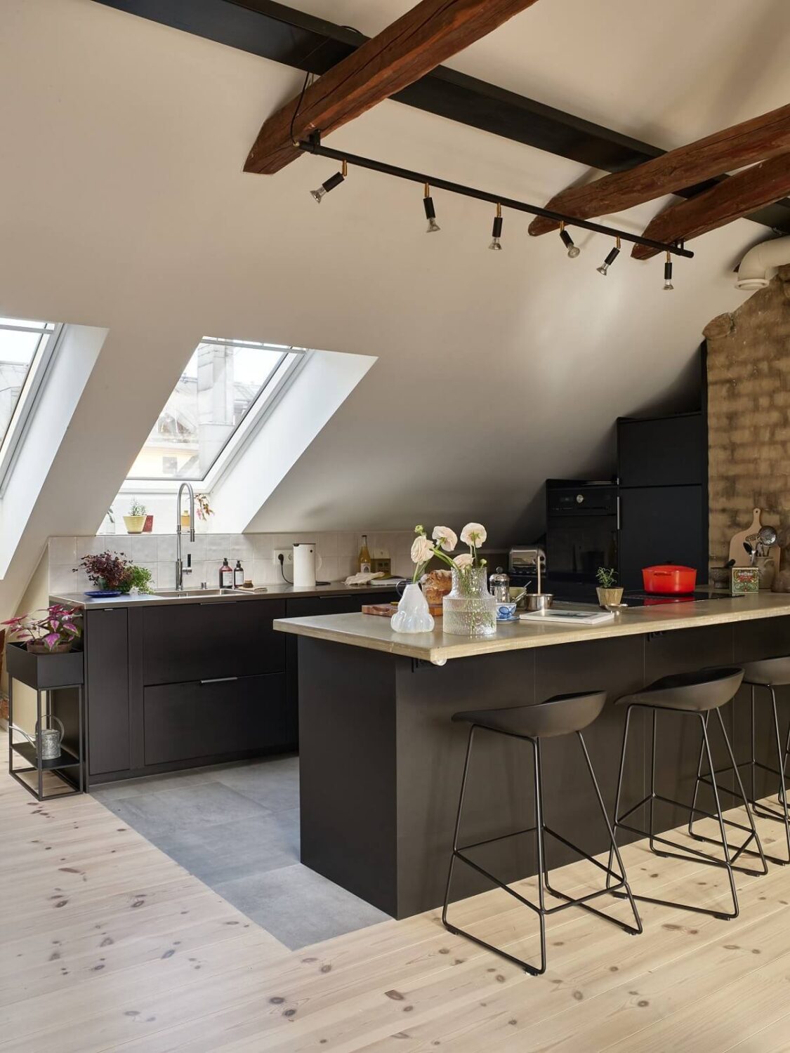 A Scandinavian Penthouse Apartment with Slanted Ceilings 2 loft-apartment-penthouse-black-kitchen-slanted-ceiling-exposed-wooden-beams-nordroom