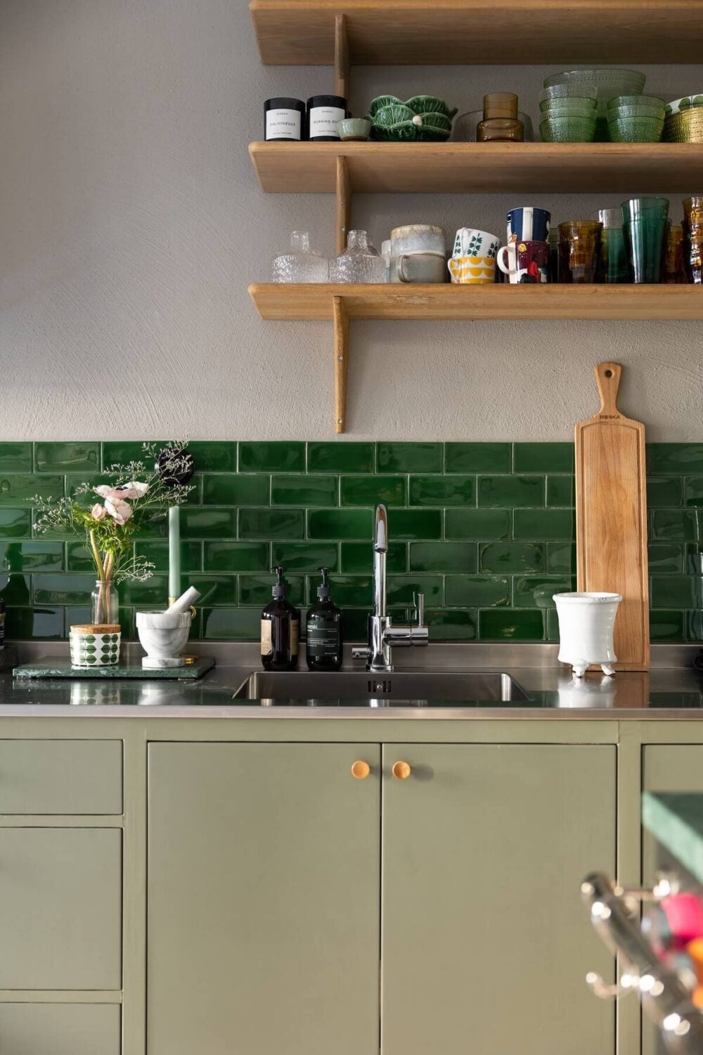 A Swedish Townhouse with a Light Green Kitchen 4 mint-green-kitchen-cabinets-green-tiles-shelves-nordroom