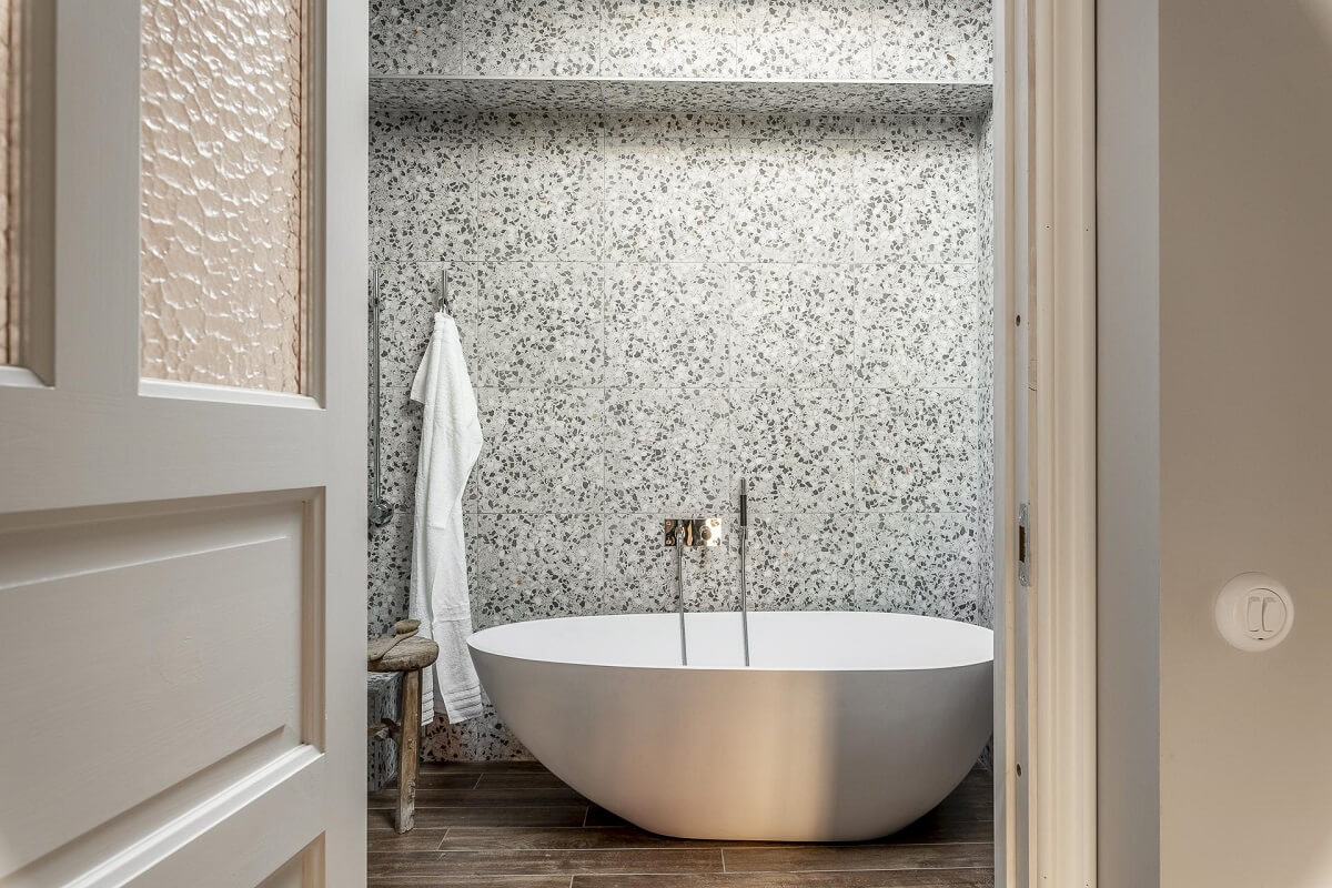 A Swedish Maisonette with a Blue Kitchen and Wallpaper 25 modern-freestanding-bath-terrazzo-tiles-nordroom