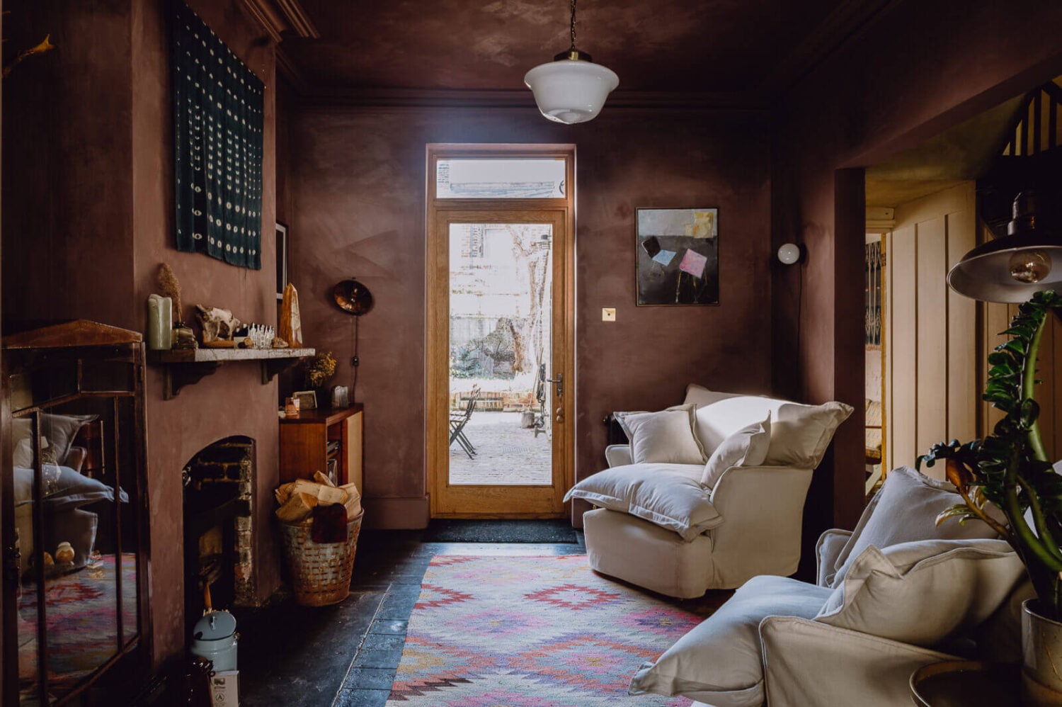 A Victorian Watch Shop is Now a Warm Sustainable Home 5 moody-pink-sitting-room-fireplace-maker-and-son-armchairs-bauwerk-dusty-limewash-paint-nordroom