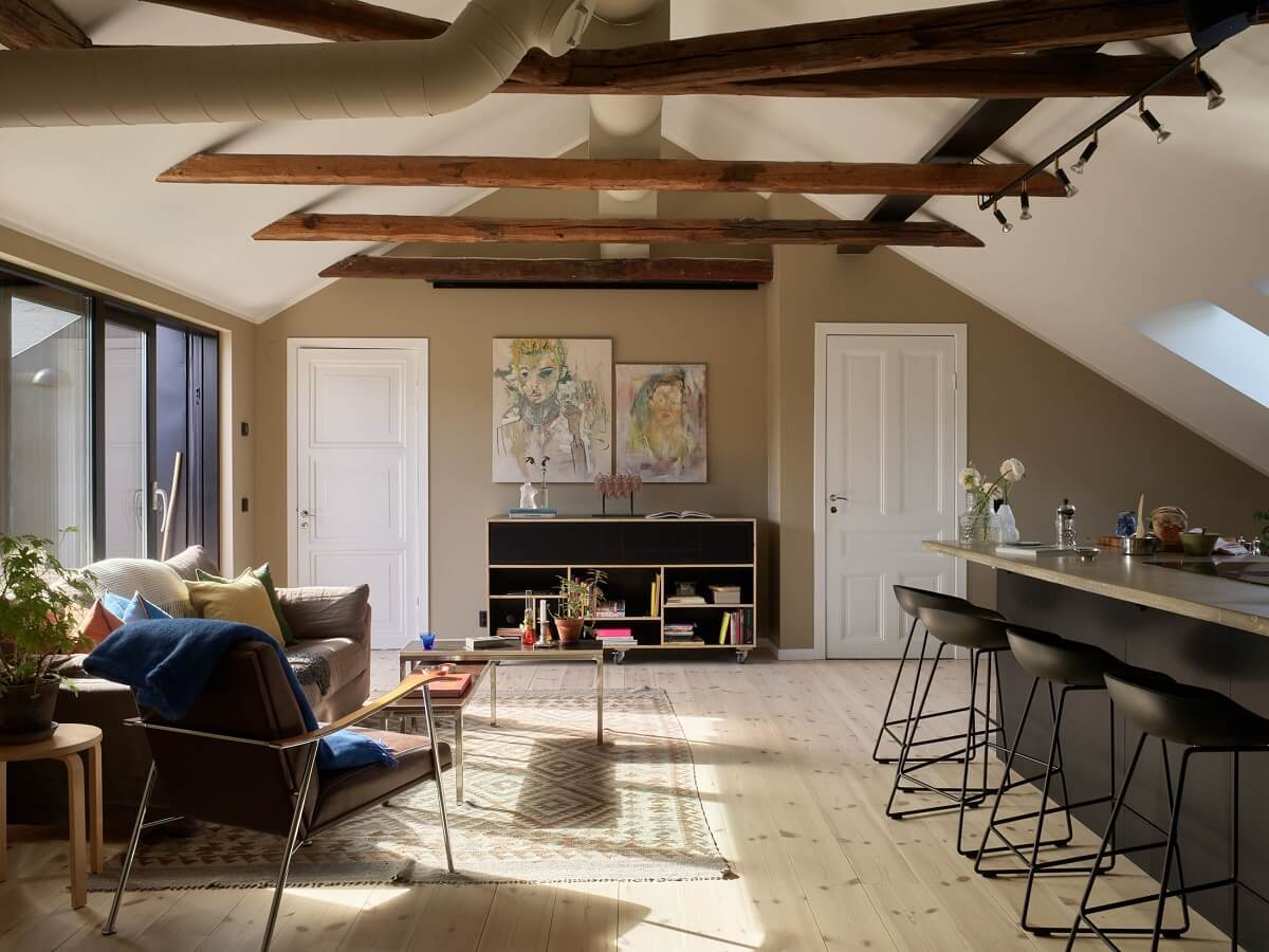 A Scandinavian Penthouse Apartment with Slanted Ceilings 7 open-plan-penthouse-living-space-wooen-ceiling-beams-nordroom