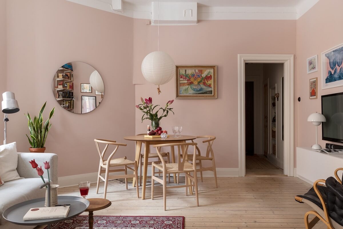 A Pink Living Room in a Scandinavian Apartment 3 pink-walls-living-room-dining-table-wooden-floor-nordroom