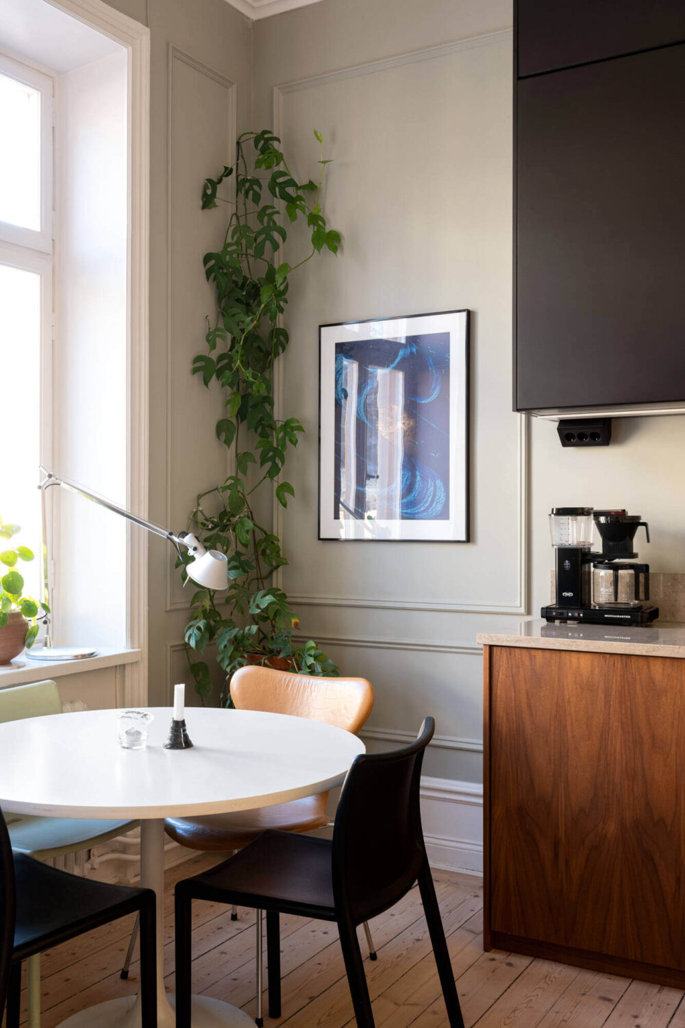A Small Stockholm Apartment with Lovely Natural Light 3 round dining table walnut kitchen skirting boards nordroom