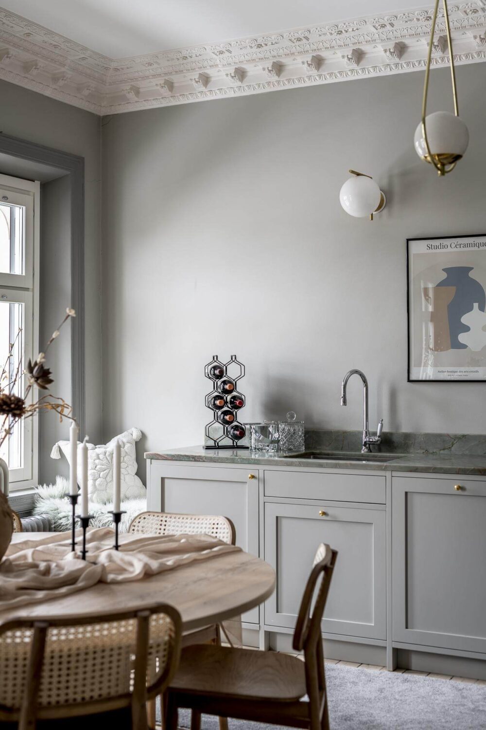 Gray Tones in a Classic Historic Scandinavian Home 16 round-wooden-dining-table-chairs-gray-cabinets-walls-nordroom
