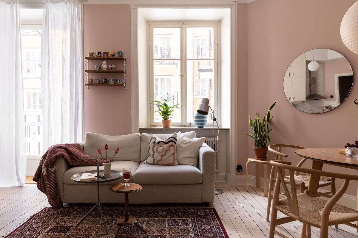 A Pink Living Room in a Scandinavian Apartment 6 scandinavian-living-room-pink-walls-round-mirror-nordroom