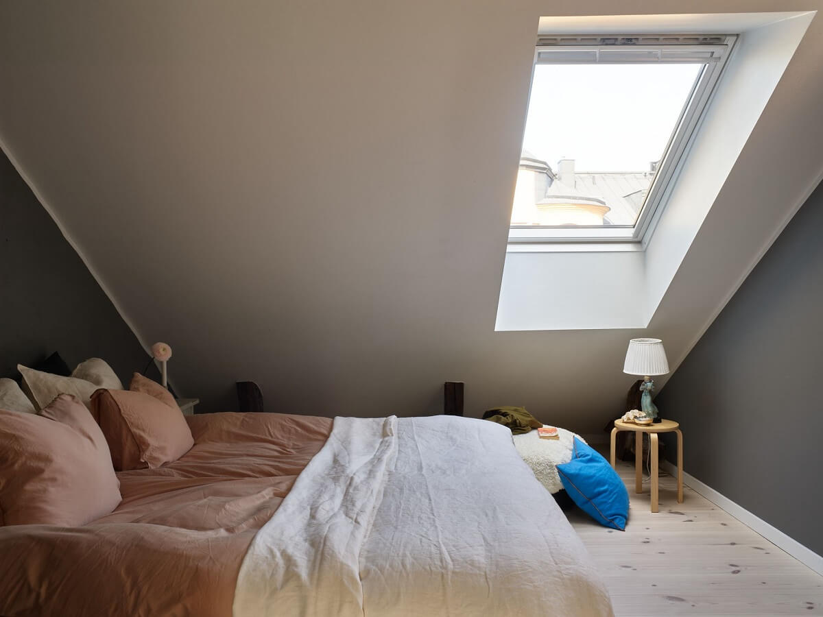 A Scandinavian Penthouse Apartment with Slanted Ceilings 17 slanted-wall-bedroom-skylight-nordroom