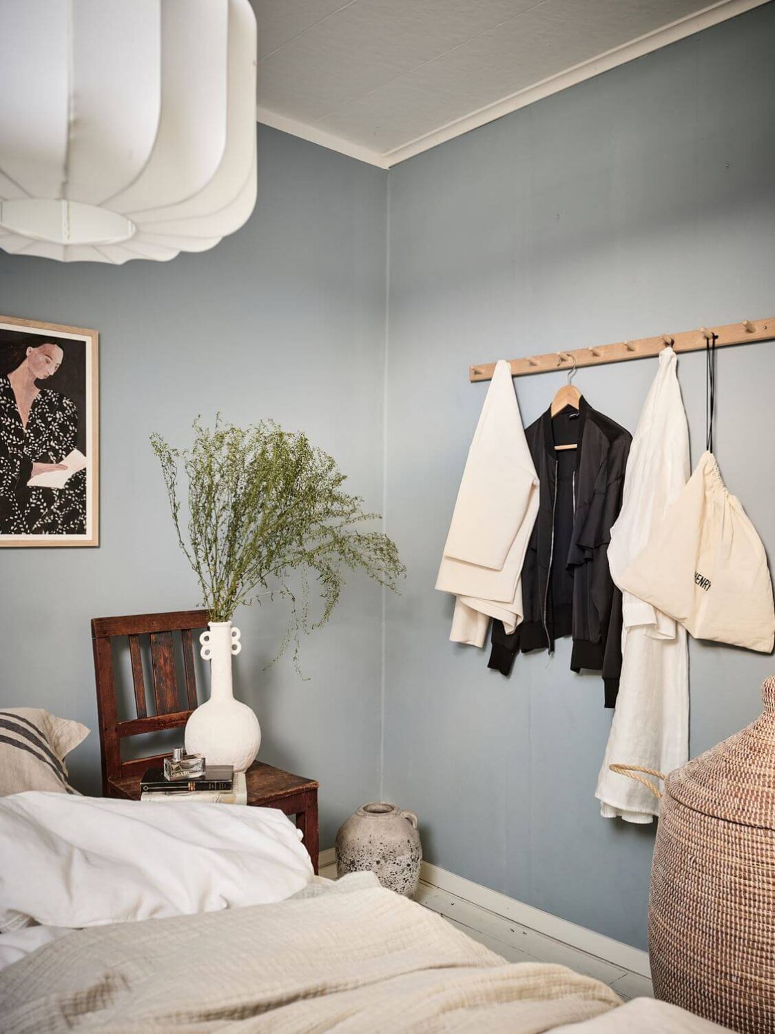 A White Scandinavian Attic Apartment 12 small-bedroom-blue-painted-walls-hanging-rack-nordroom