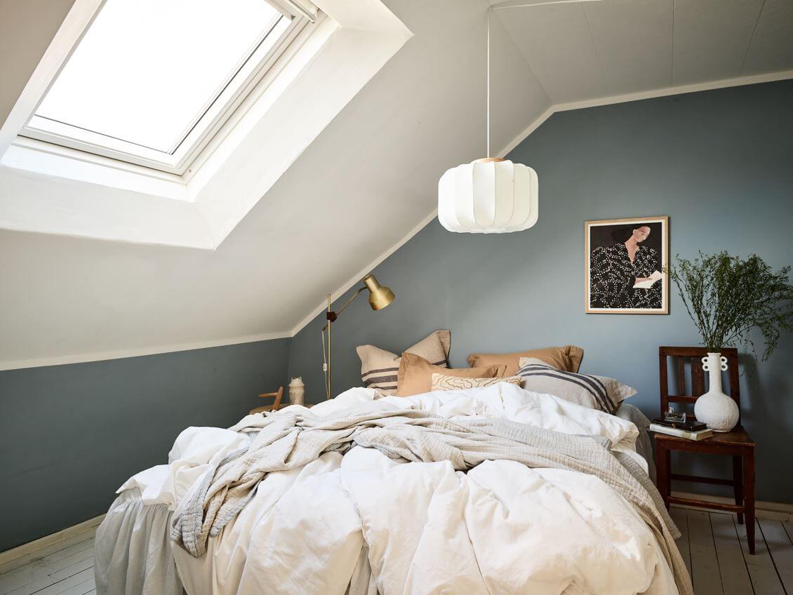 A White Scandinavian Attic Apartment 11 small-bedroom-slanted-ceiling-blue-walls-nordroom
