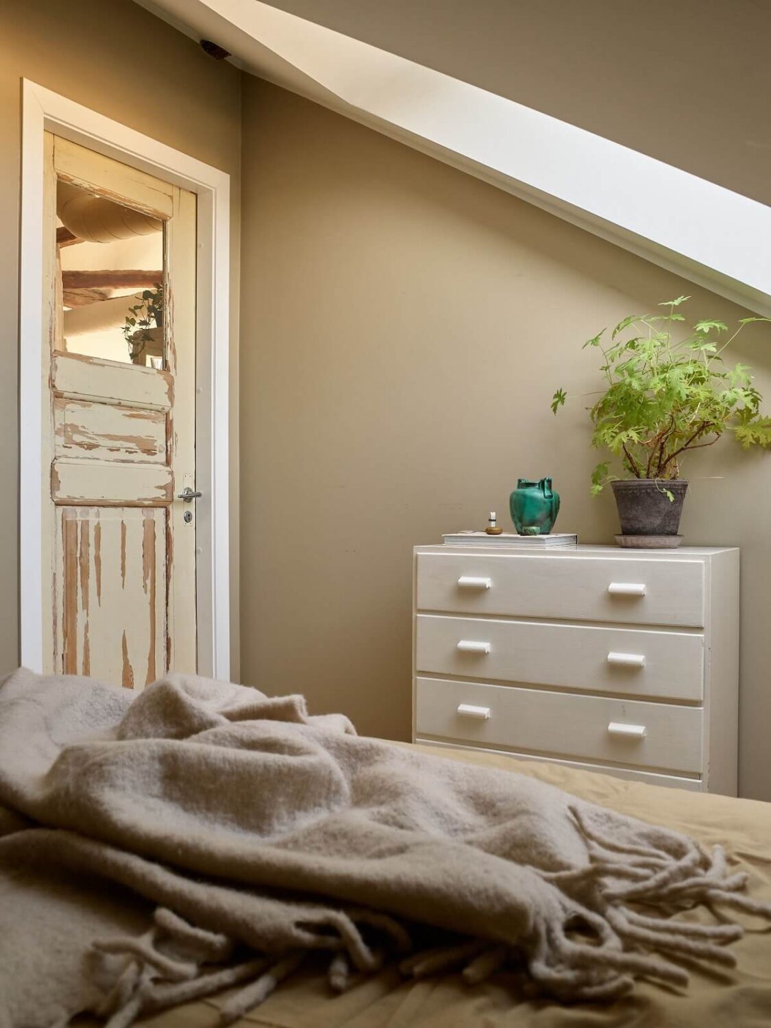 A Scandinavian Penthouse Apartment with Slanted Ceilings 15 small-bedroom-slanted-ceiling-reclaimed-wooden-door-nordroom