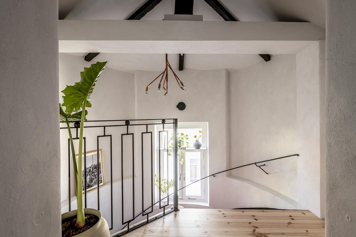 A Swedish Maisonette with a Blue Kitchen and Wallpaper 14 staircase-hallway-wooden-floorboards-swedish-maisonette-nordroom
