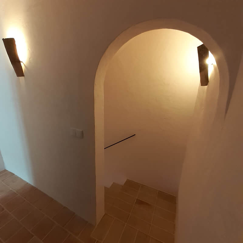Casita Alborán: A Stylish Home in a Spanish Seaside Town 18 staircase-stone-floor-arched-doorway-nordroom