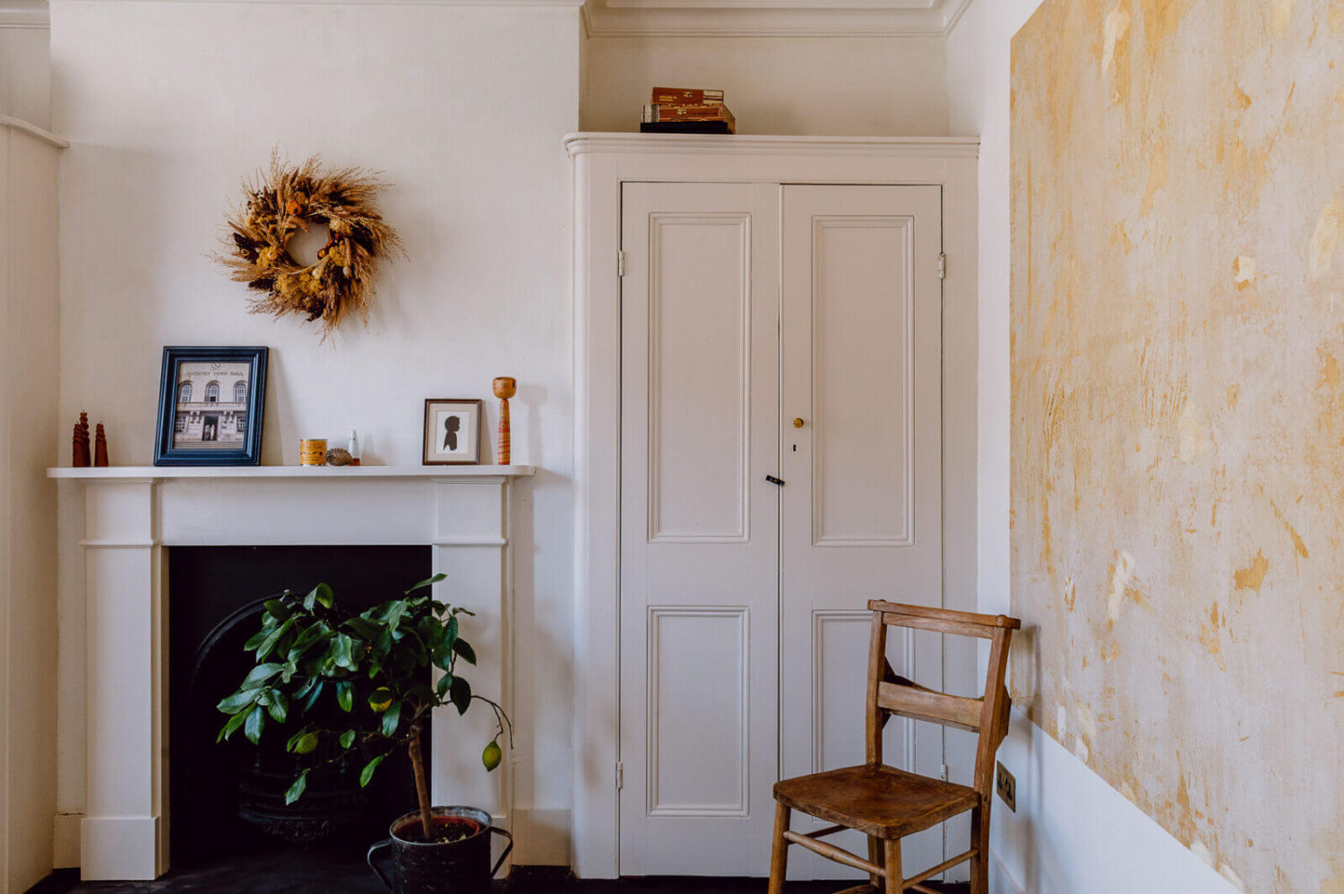 A Victorian Watch Shop is Now a Warm Sustainable Home 15 white-bedroom-fireplace-wardrobe-nordroom
