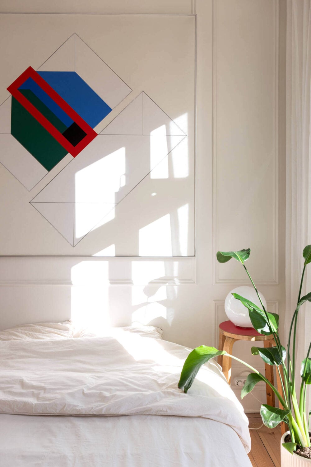 A Small Stockholm Apartment with Lovely Natural Light 12 white bedroom large artwork above bed nordroom