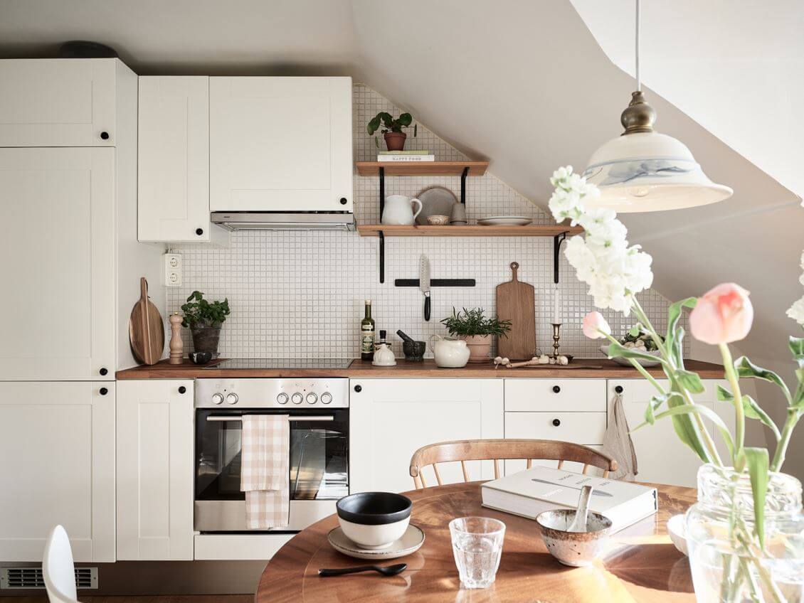 A White Scandinavian Attic Apartment 18 white-kitchen-slanted-walls-shelves-nordroom
