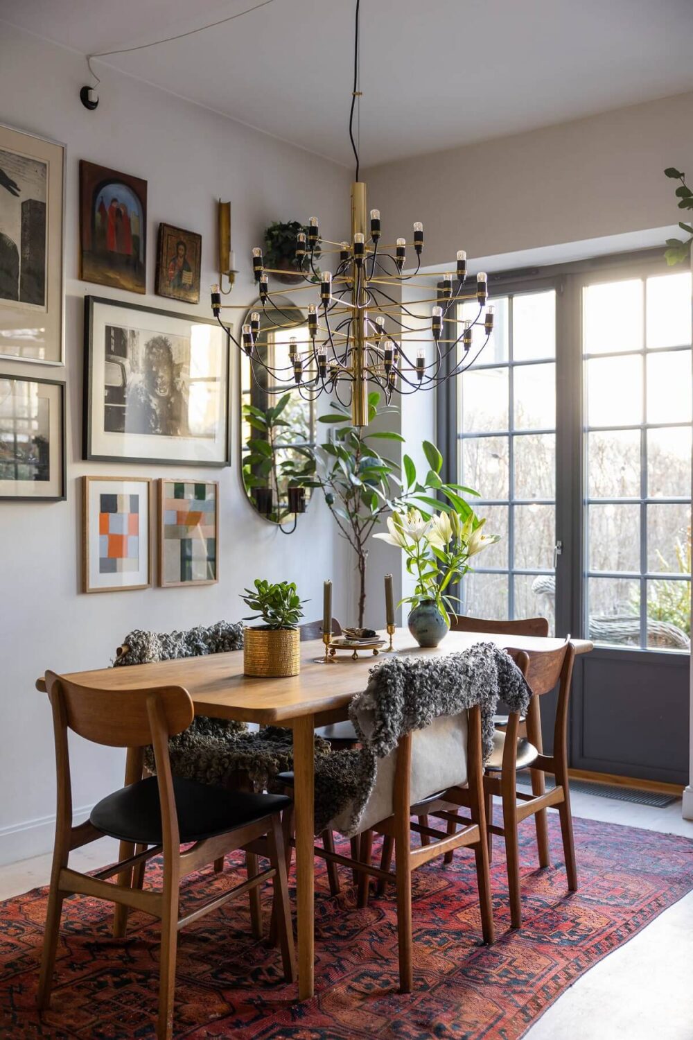 A Swedish Townhouse with a Light Green Kitchen 2 wooden-dining-table-rug-gallery-wall-nordroom