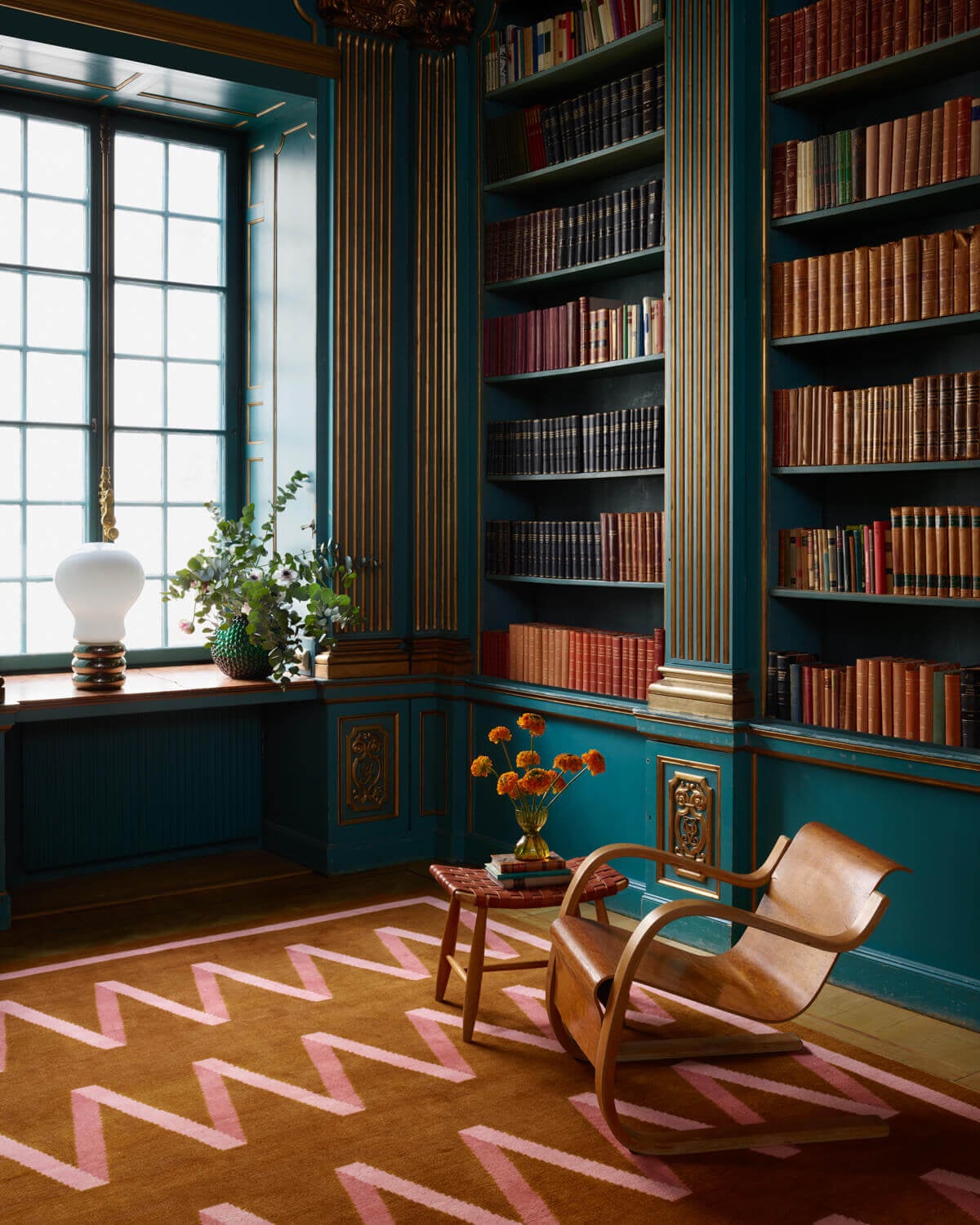 36 Home Library Ideas That Are A Book-Lover's Dream 17 Folding-Ribbon-teal-bookcases-campbell-rey-nordic-knots-rug-collection-nordroom