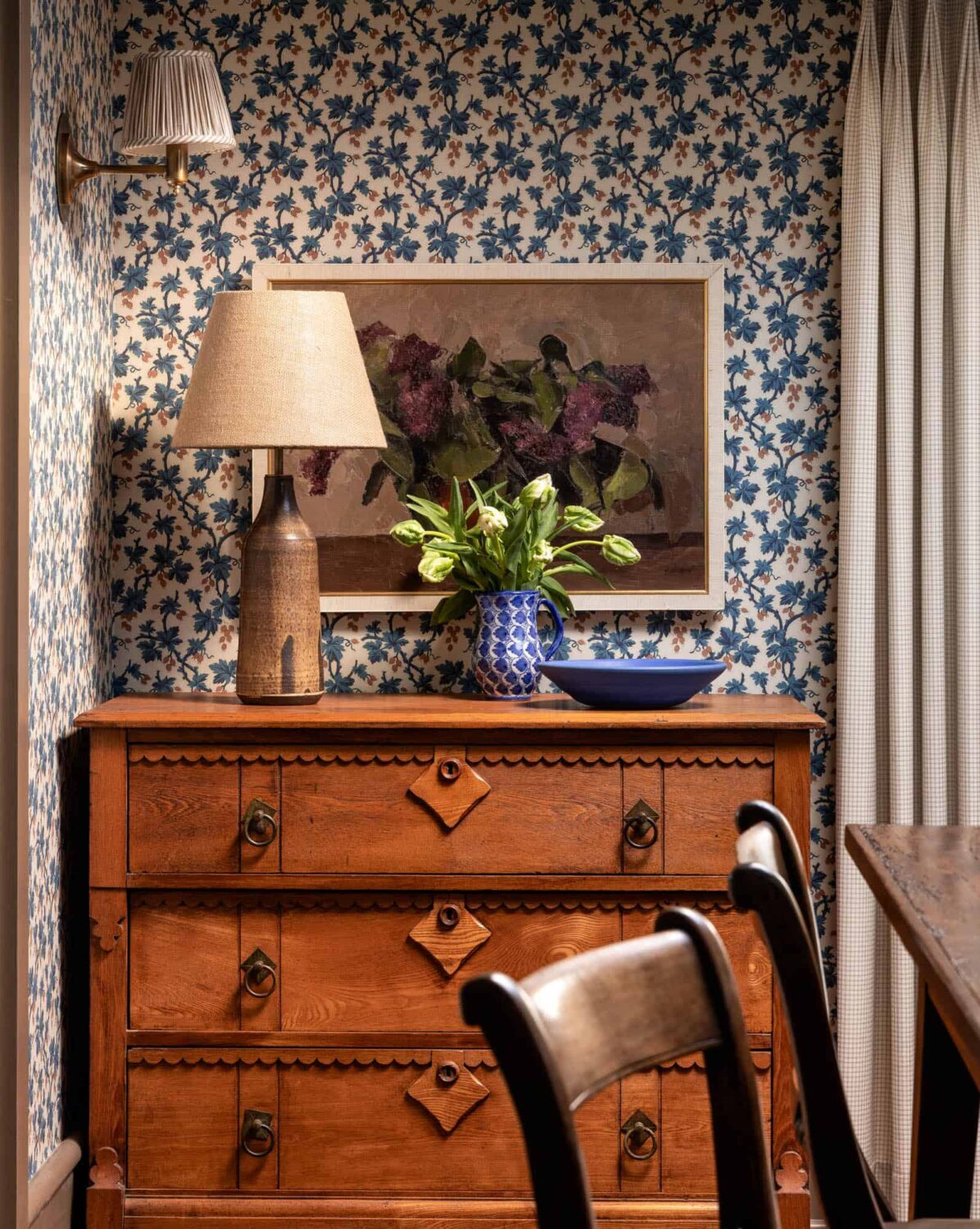 A Cozy Pied-à-Terre with Slanted Ceilings and Wallpaper 12 antique-dresser-blue-floral-wallpaper-dining-room-nordroom