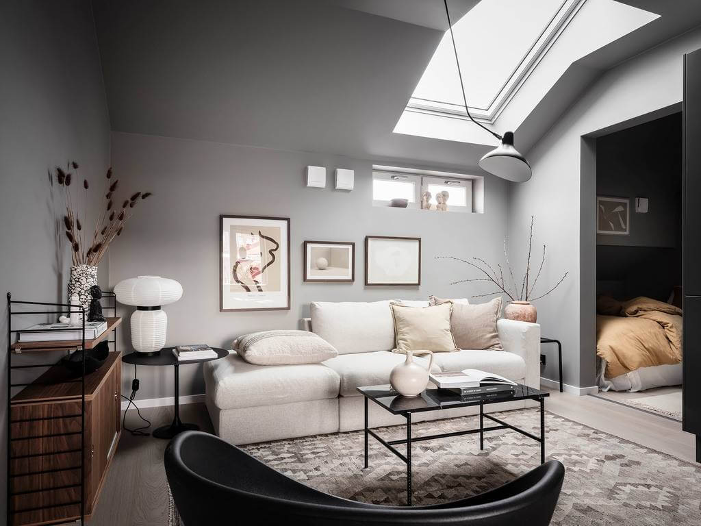 A Small Gray Attic Apartment in Sweden 2 apartment-slanted-ceiling-skylight-bedroom-niche-nordroom