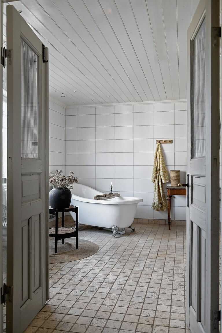 An Idyllic Family Home in the Swedish Countryside 21 bathroom-double-wooden-doors-clawfoot-bath-nordroom