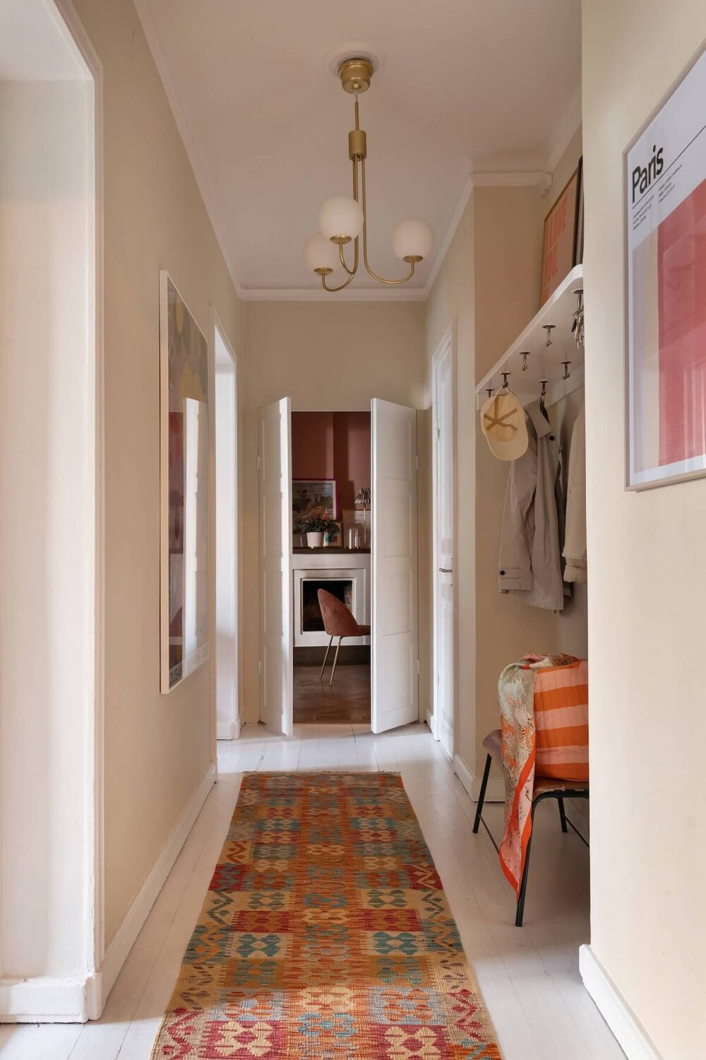 A Serene Nordic Apartment with Pink Color Accents 23 beige-hallway-niche-coat-storage-colorful-runner-nordroom