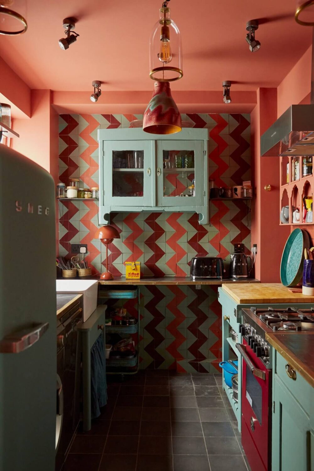 Jewel-Toned Hues in a Vibrant Eclectic Mews House 9 colorful-kitchen-red-ochre-walls-ceiling-colorful-moroccan-tiles-nordroom