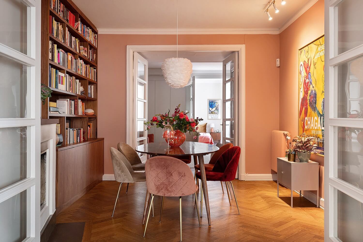 A Serene Nordic Apartment with Pink Color Accents 13 dining-room-pink-walls-bookcase-pink-velvet-chairs-wooden-floors-nordroom