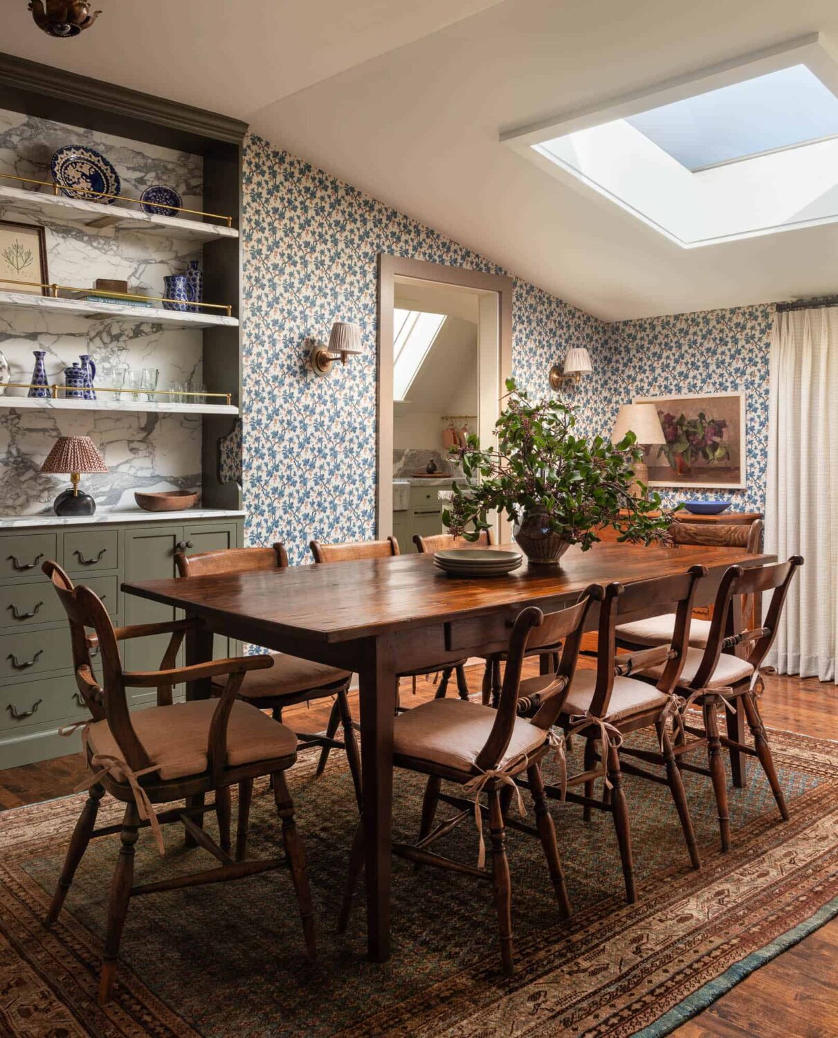 A Cozy Pied-à-Terre with Slanted Ceilings and Wallpaper 10 dining-room-skylight-slanted-ceiling-wallpaper-rug-nordroom